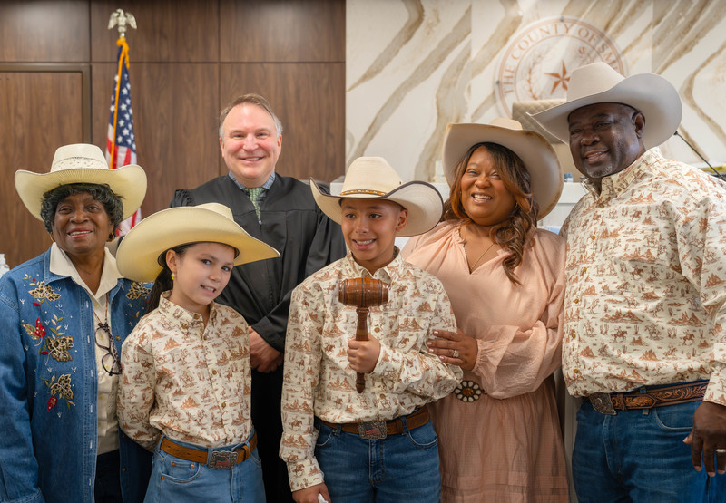 group of men, women, and kids with a judge