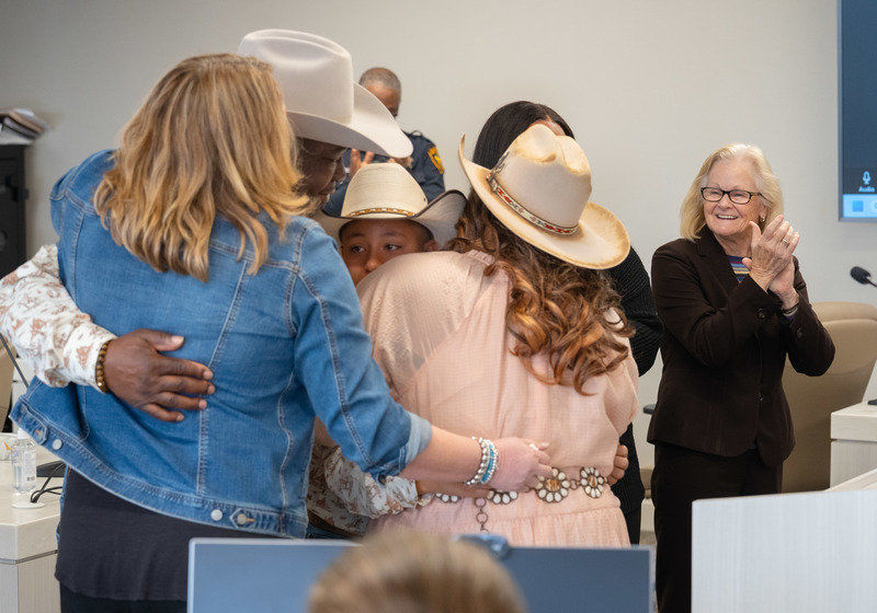 man, women, and boy hugging