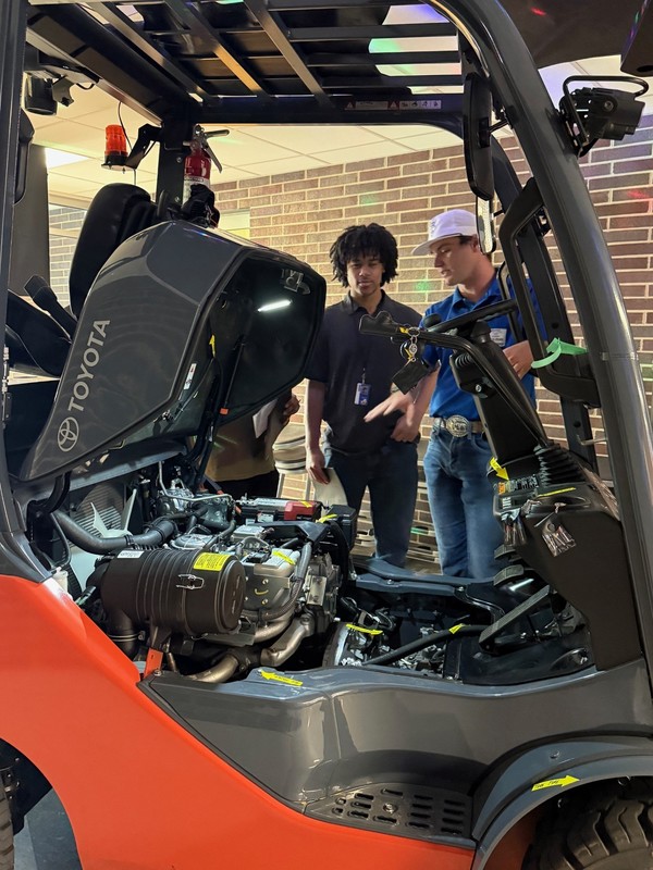 teens working on a forklift
