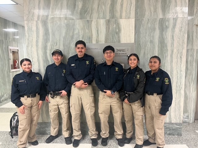 teen boys in black shirts and khaki pants