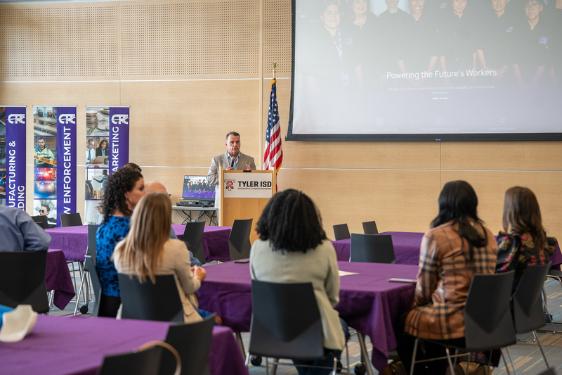 man talking to crowd of people