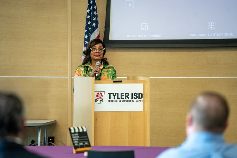 woman using microphone to address crowd