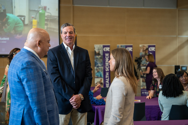 men and woman talking in room