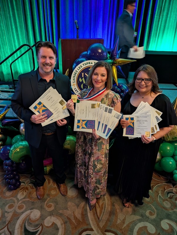 man and two women holding certificates