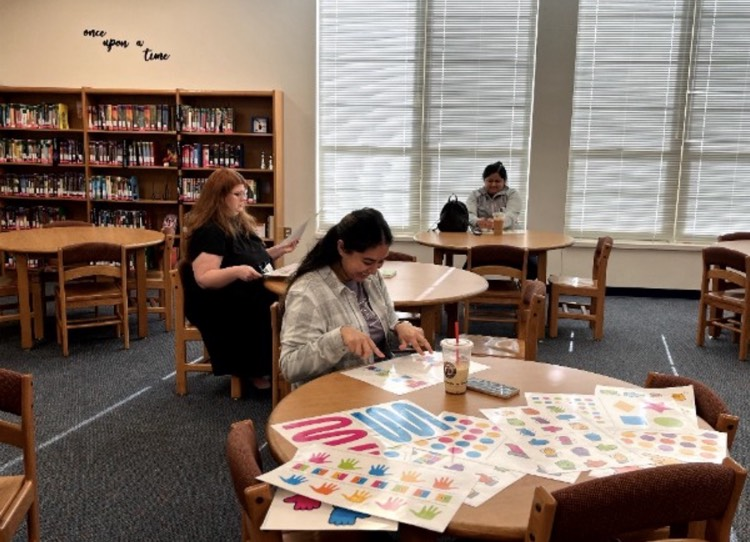 parent at table in library