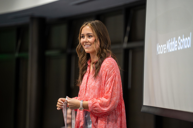teen girl holding medals
