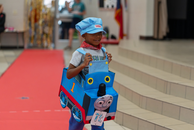 young boy dressed like Thomas the Train