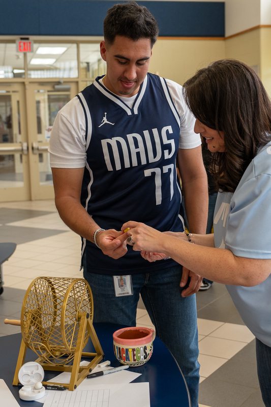 man receiving piece of paper from woman