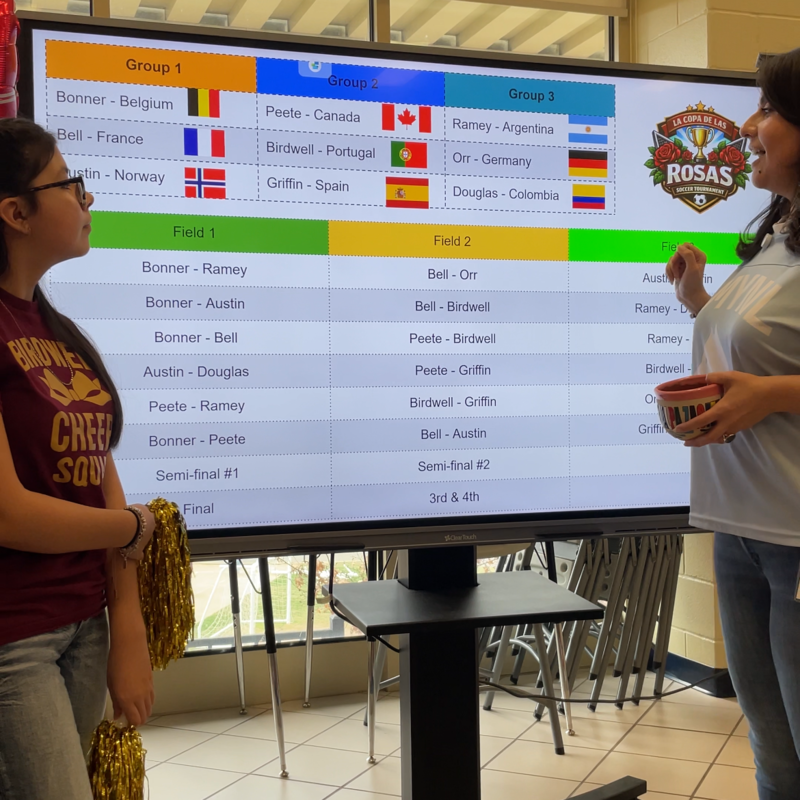 two women looking at tv screen
