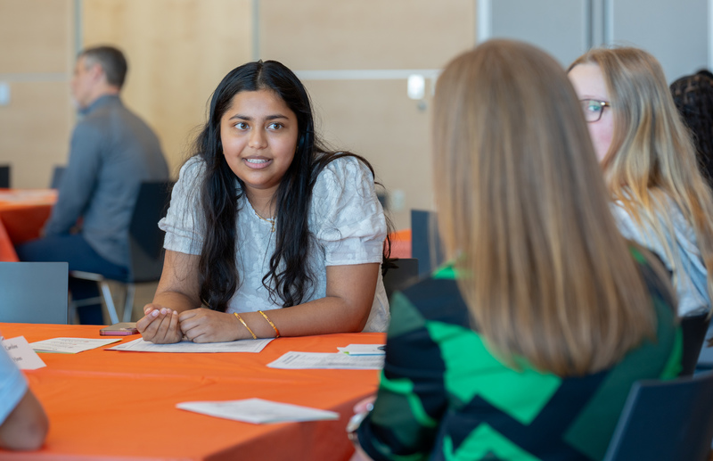 teen girls talking at a table