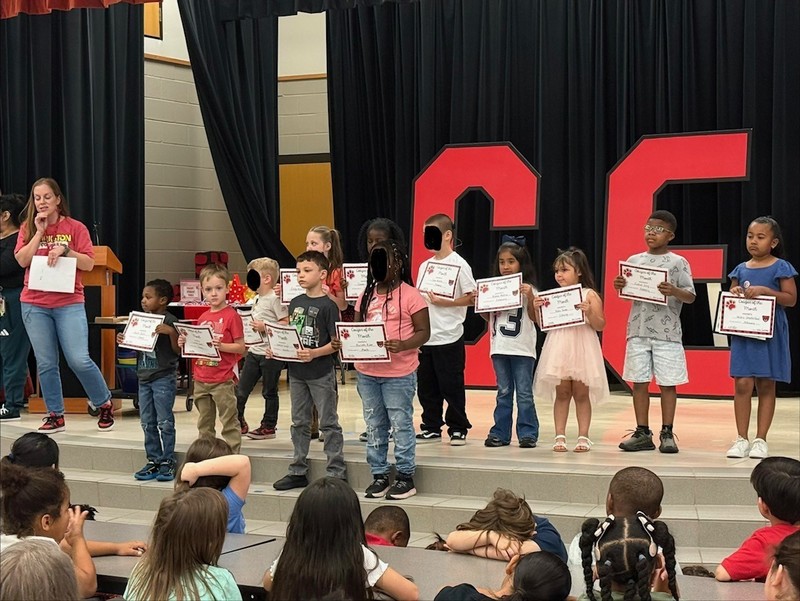 students holding awards