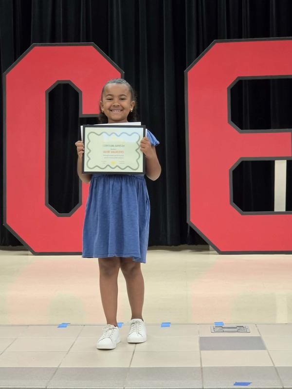 students holding awards