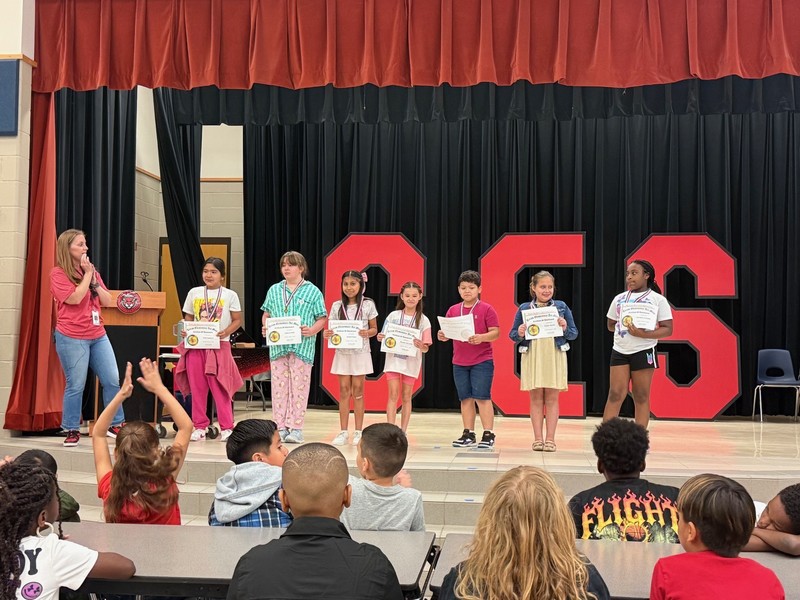 students holding awards