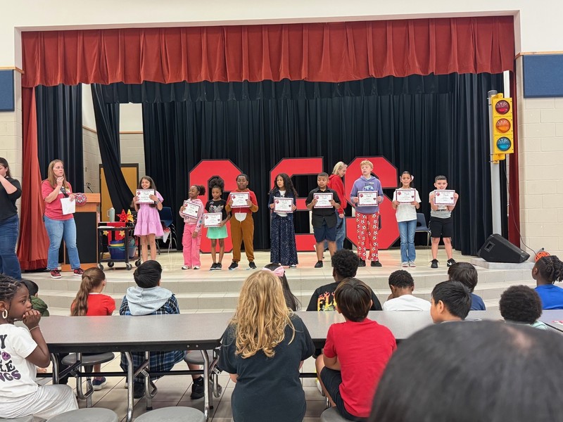 students holding awards