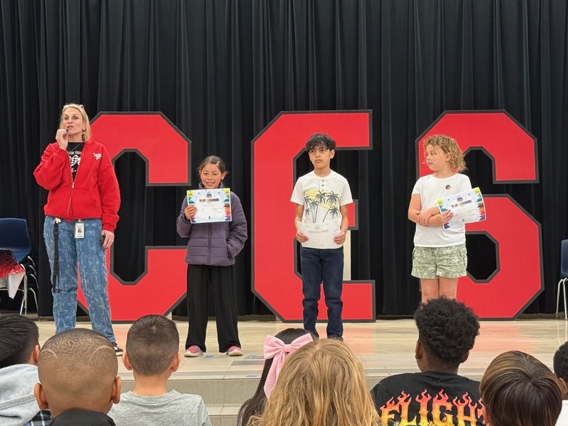 students holding awards