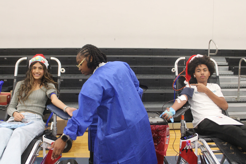 two teens on chairs at blood drive
