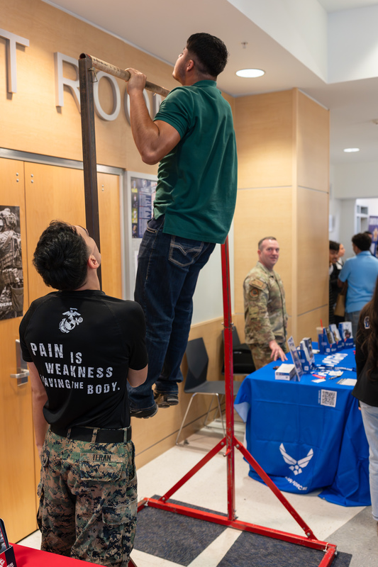 teen boy doing pullup on a bar