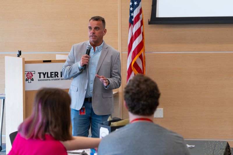 man with microphone talking to crowd