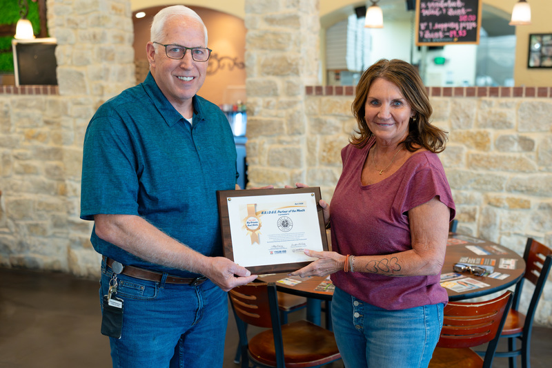 man and woman holding a certificate