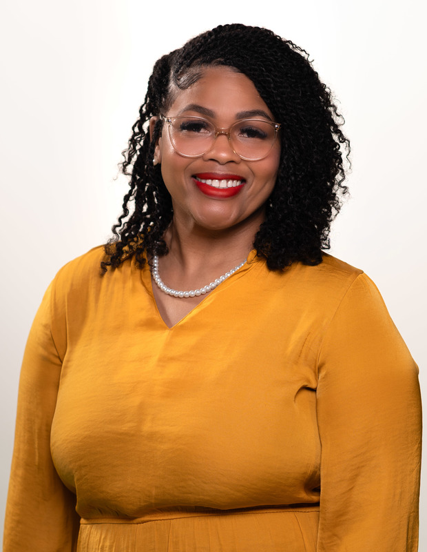 African AMerican woman wearing orange top smiling