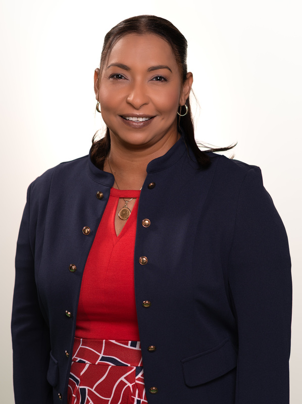 woman wearing blue blazer and red blouse smiling