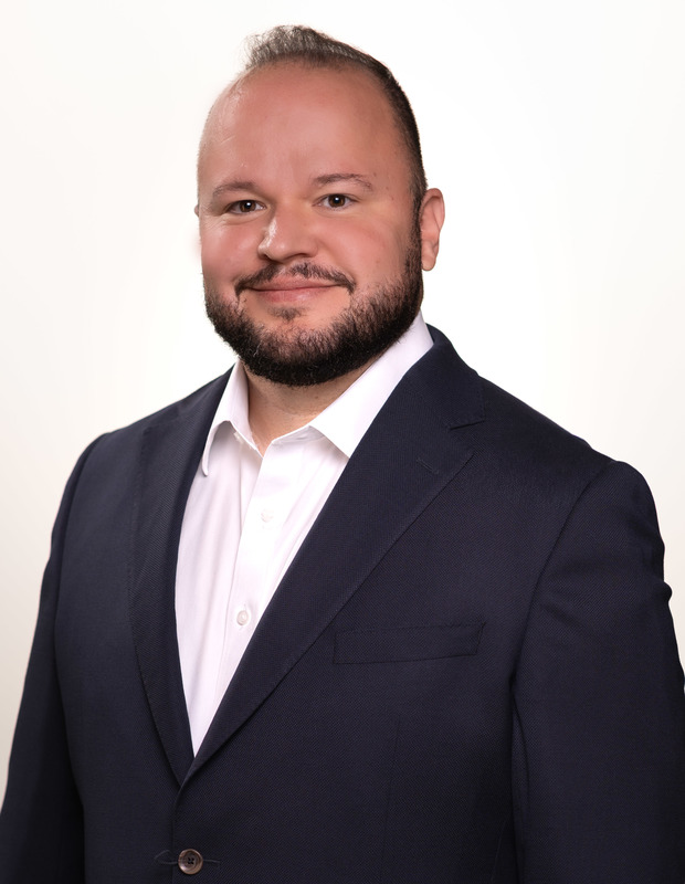 Caucasian man in blue jacket and white shirt