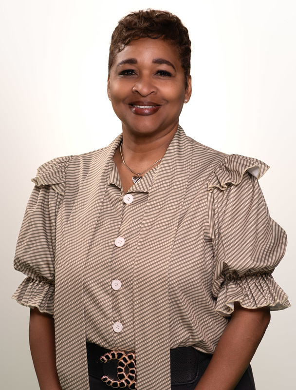 African American woman wearing tan striped blouse smiling