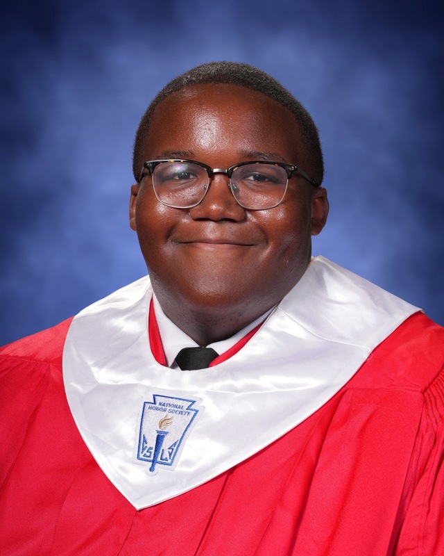 teen boy in red graduation gown with white stole