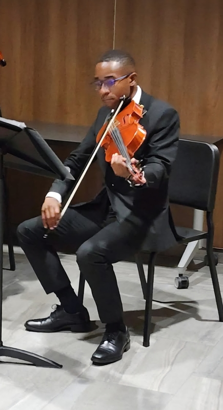 teen boy playing instrument