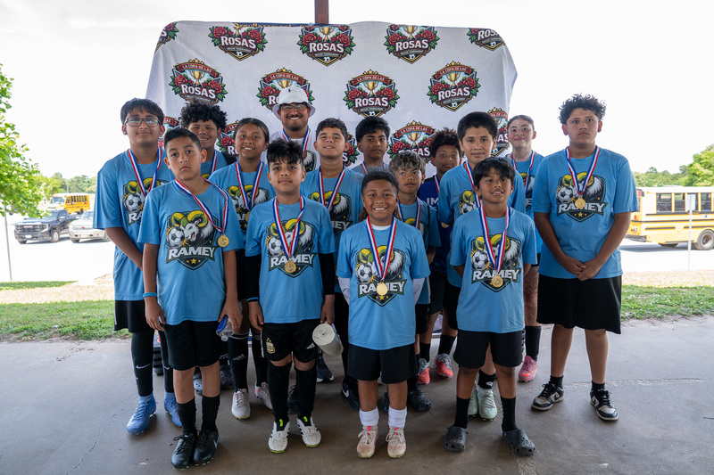 elementary age kids in blue soccer jerseys 