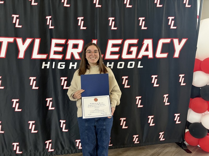teen girl holding certificate