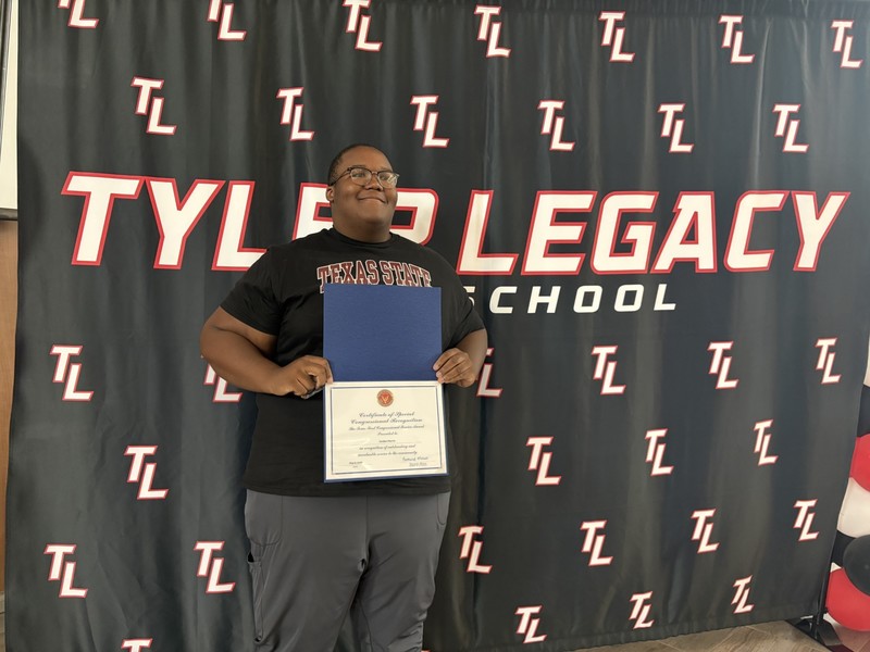 teen boy holding certificate