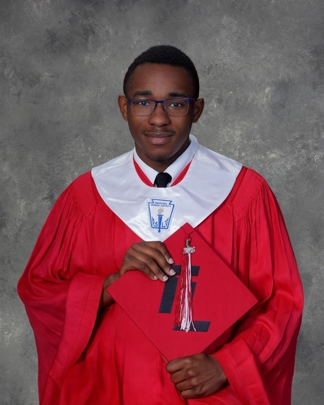 teen boy in red graduation gown
