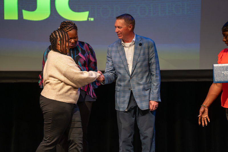 man shakes hand with teen girl