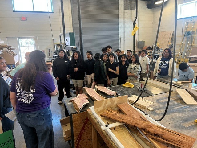 elementary kids looking at woodwork in construction lab