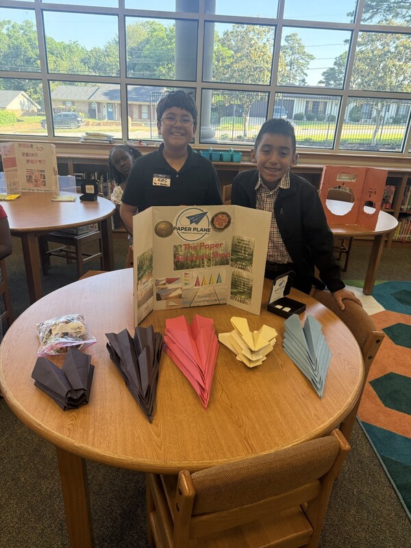 students standing with their business and merchandise