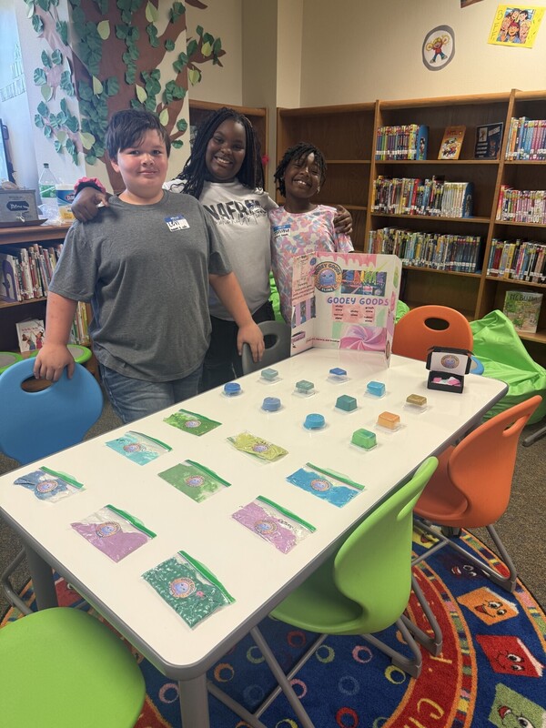 students standing with their business and merchandise