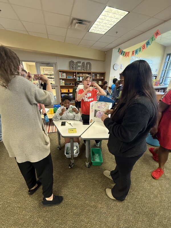 students standing with their business and merchandise