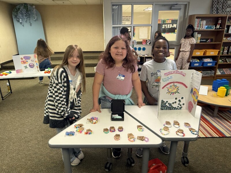 students standing with their business and merchandise