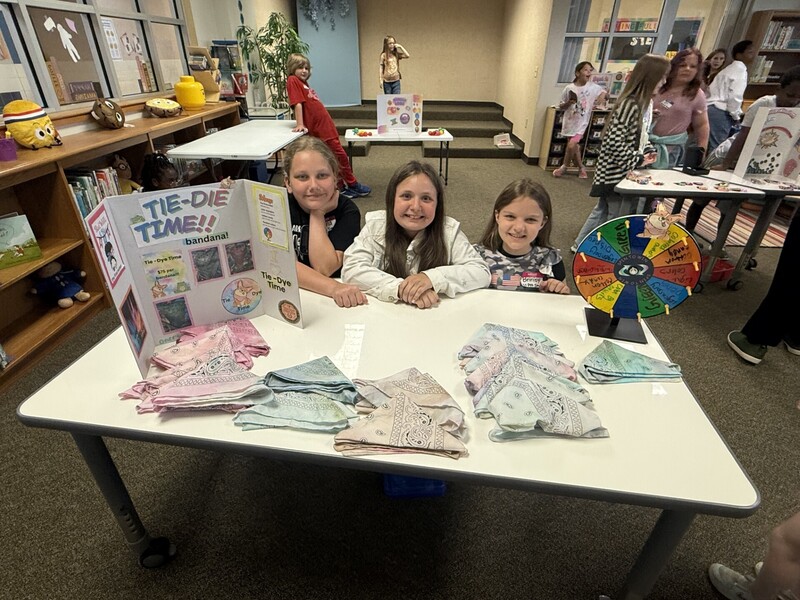 students standing with their business and merchandise