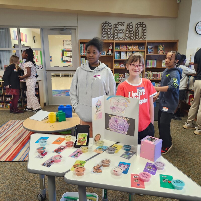 students standing with their business and merchandise