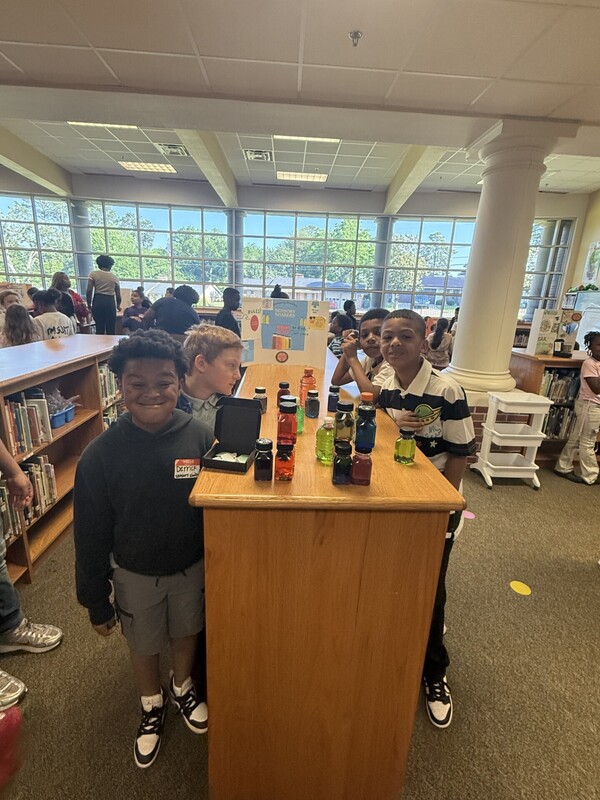 students standing with their business and merchandise