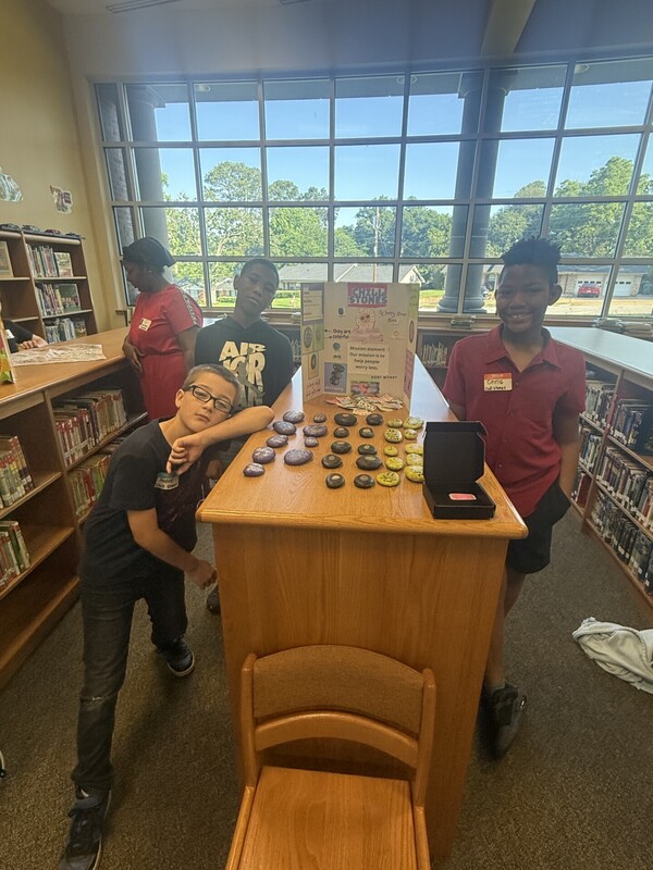 students standing with their business and merchandise