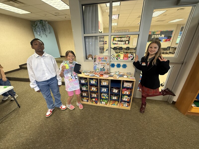 students standing with their business and merchandise