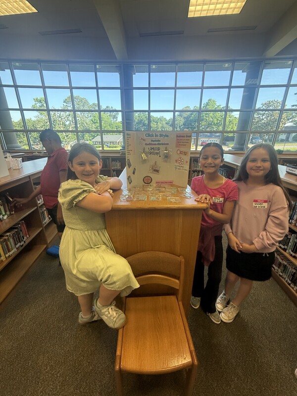 students standing with their business and merchandise