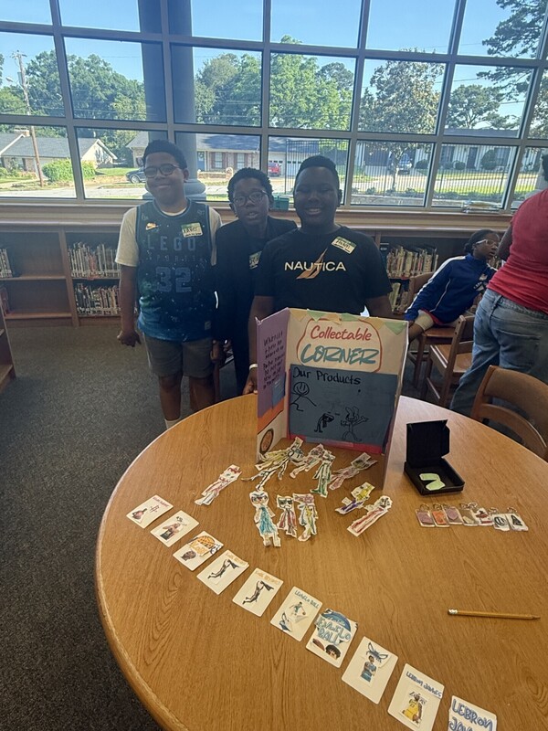 students standing with their business and merchandise