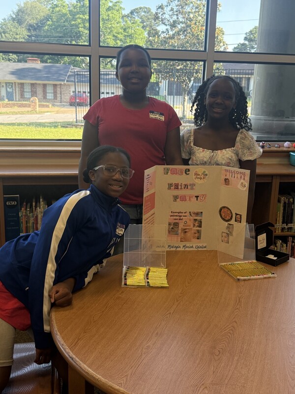 students standing with their business and merchandise
