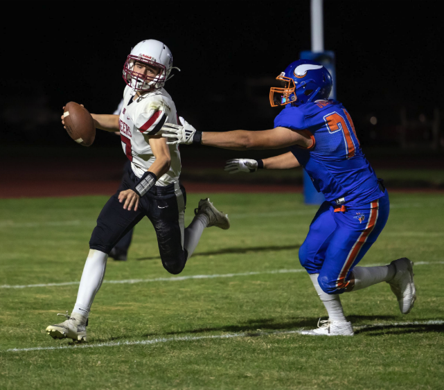 Photo by Kathy Aney Mac-Hi quarterback Randall Montgomery attempts to evade Umatilla defender Josue Arroyo (74) on Oct. 9, 2025, in Umatilla.