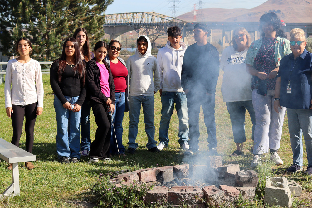 Photo of students with paraprofessionals and teacher Karen Laurence