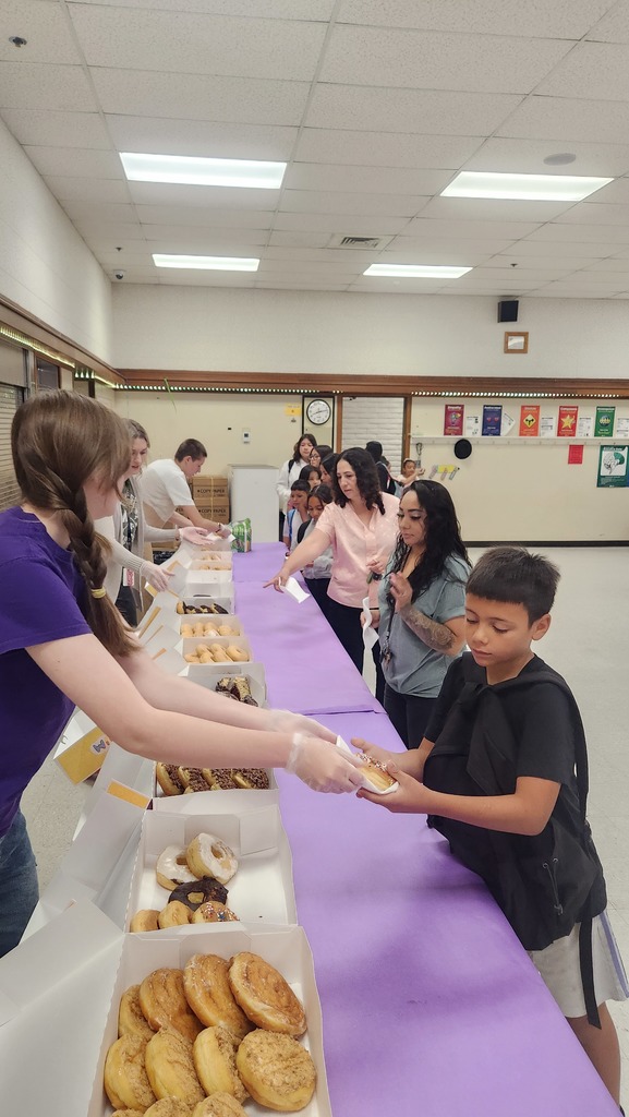 students and families enjoying donuts